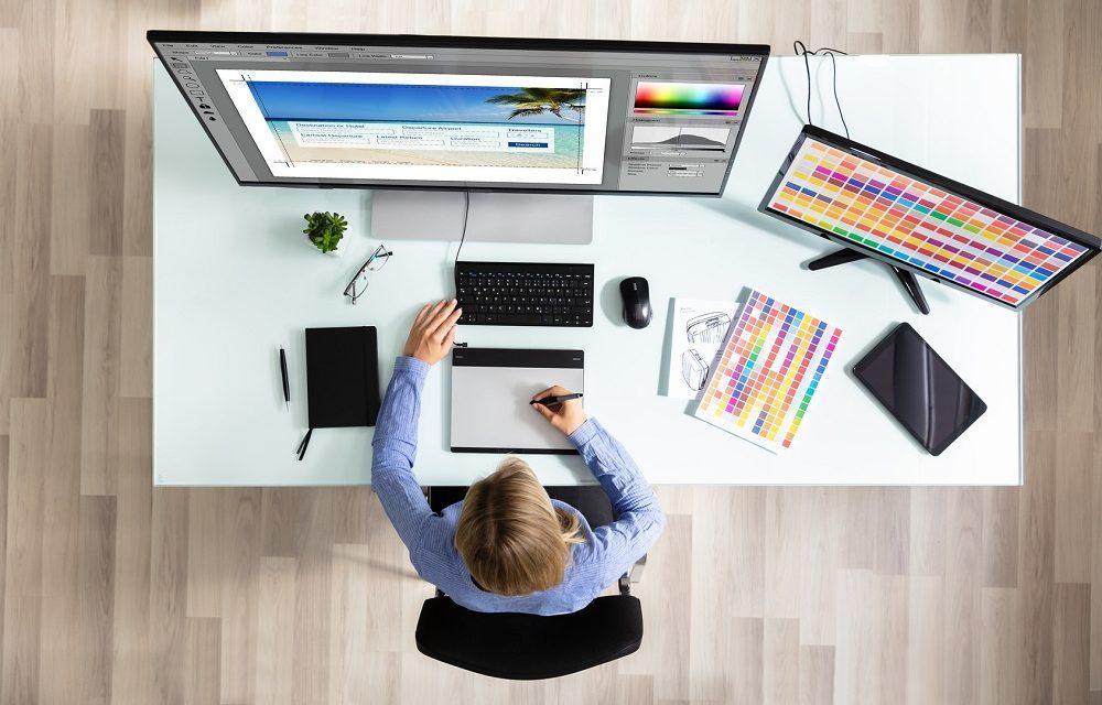 female editor using graphic tablet while working on computer